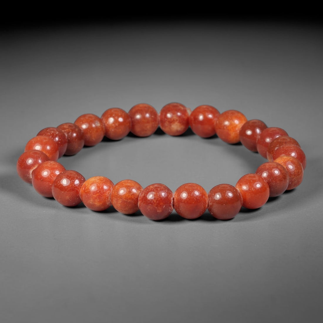 Natural Burmese Type A Uniform Russet Red Jadeite Jade Beaded Bracelet, 75TA: Crafted from fully untreated authentic Burmese Type A jadeite, this bracelet features smoothly polished small-medium round beads with consistent natural warm russet red hue, interspersed with subtle l
