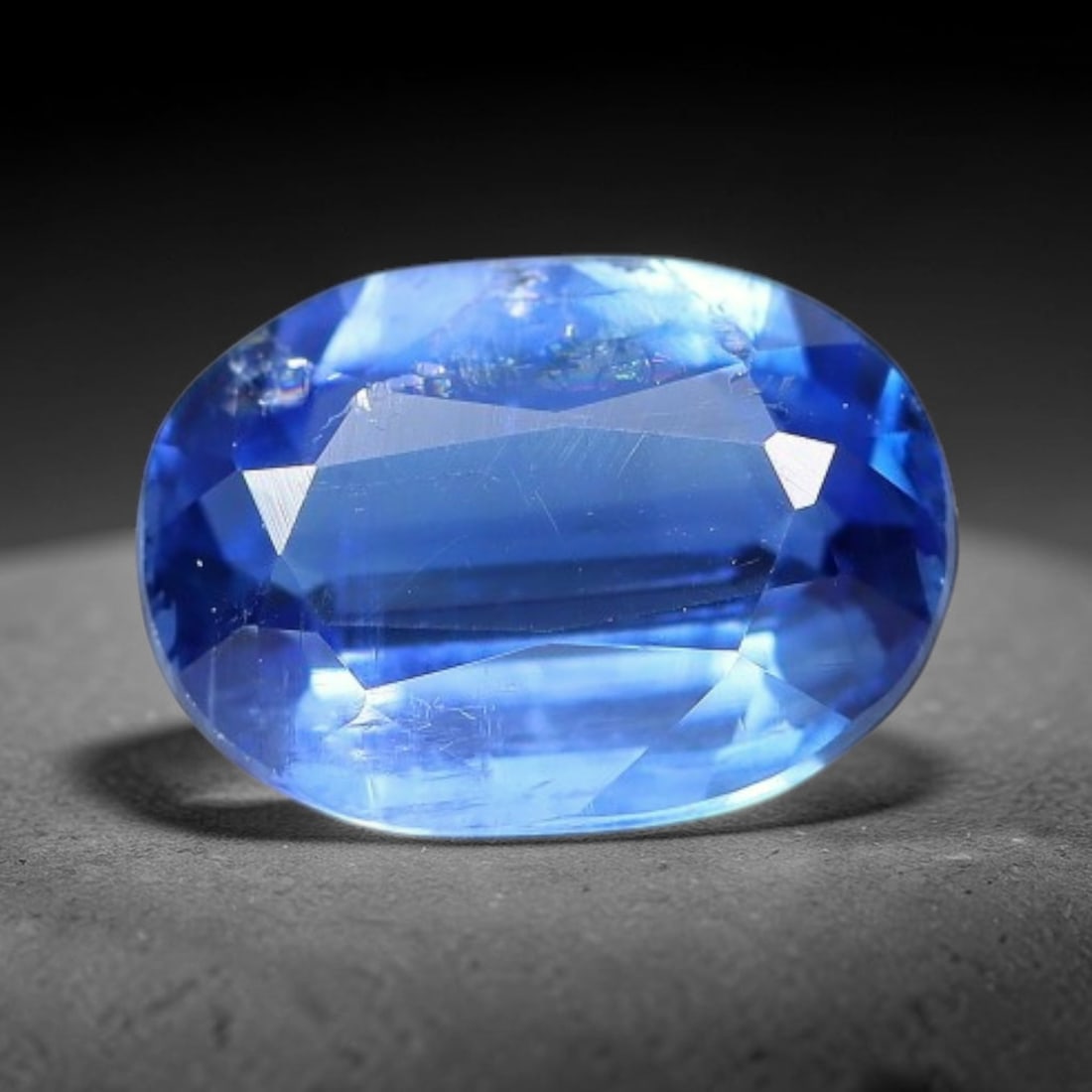 1.46 Carats Natural Brazilian Kyanite Oval Faceted Loose Gemstone, 65XY: This specimen consists of natural kyanite mineral material refined via professional faceted lapidary work, with uniform polished surfaces across the crystal exterior. Natural internal particulate mark