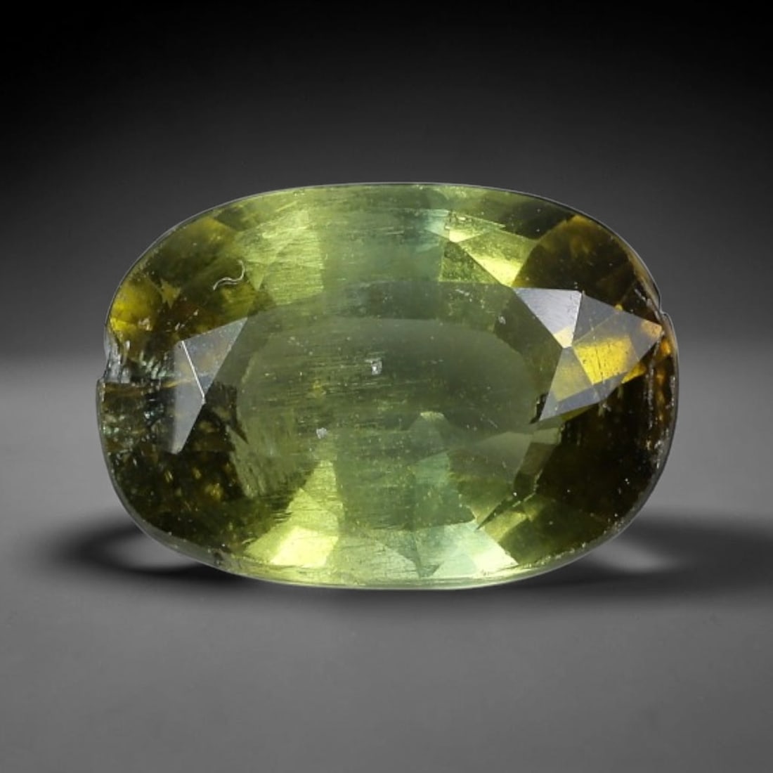 1.43 Carats Yellow-Green Tourmaline Oval Cut - Natural Loose Gemstone, 62XC: This striking oval-cut tourmaline features a captivating yellow-green hue, reminiscent of sunlight filtering through fresh spring foliage. Its faceting creates a dazzling play of light, with subtle co