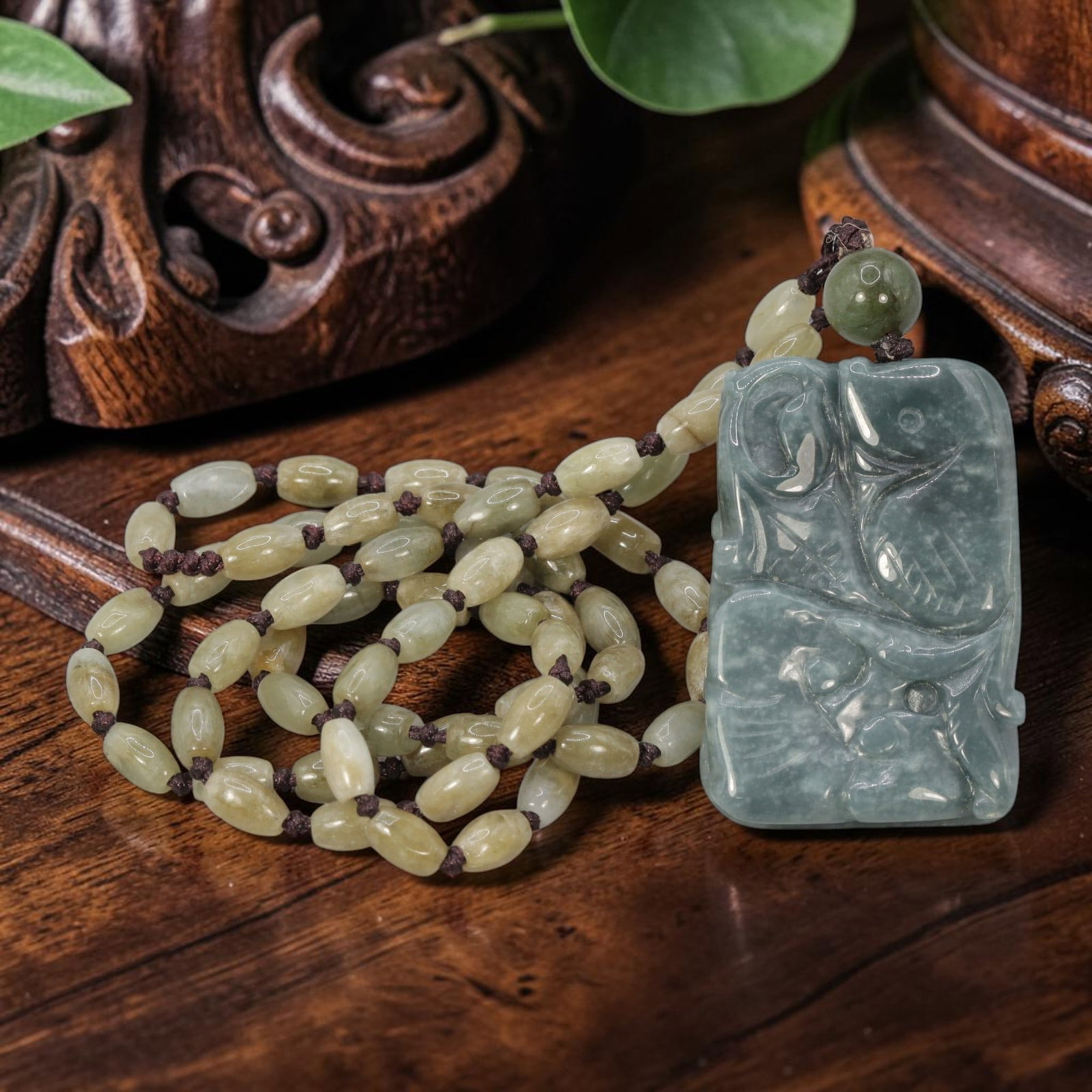 Burmese Jadeite Beaded Necklace with Natural Chinese Jade Fish Pendant, 66YJ: This necklace features a hand-carved natural Chinese jade fish pendant paired with natural Burmese jadeite pebble beads, strung on a brown cord. The pendant is crafted from soft greenish-blue jade, de