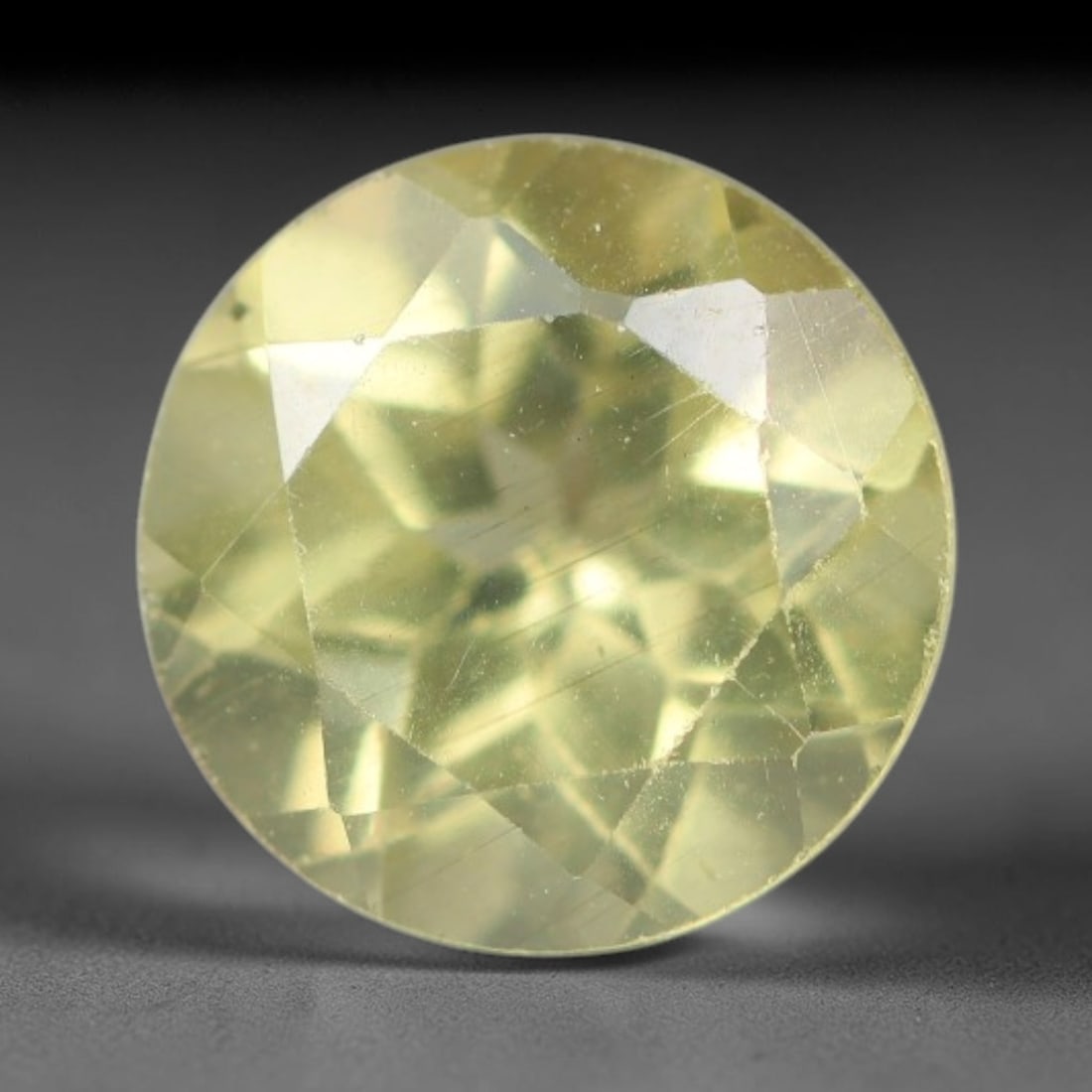 1.96 Carats Natural Pale Yellow Apatite Faceted Loose Gemstone, 50XY: This apatite specimen is sourced from natural geological deposits and shaped with professional faceting and high-gloss polishing work across the outer facet surfaces. Minute internal mineral inclusion