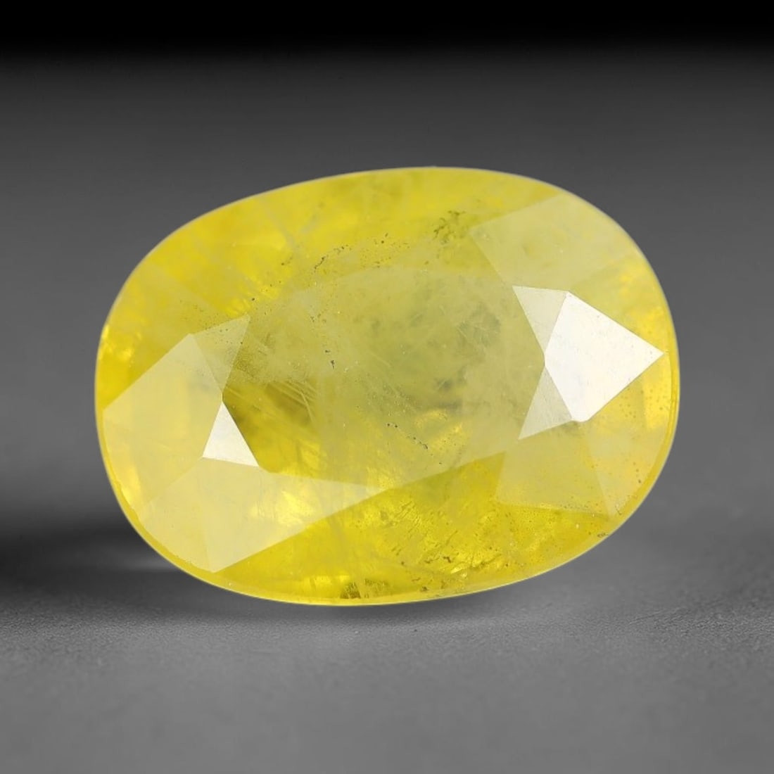 3.37 Carats Natural Yellow Sapphire Oval Faceted Loose Gemstone, 91XM: This natural yellow sapphire features a classic oval brilliant faceted cut, holding consistent warm golden-yellow color throughout the corundum crystal. Fine microscopic mineral specks and faint natur