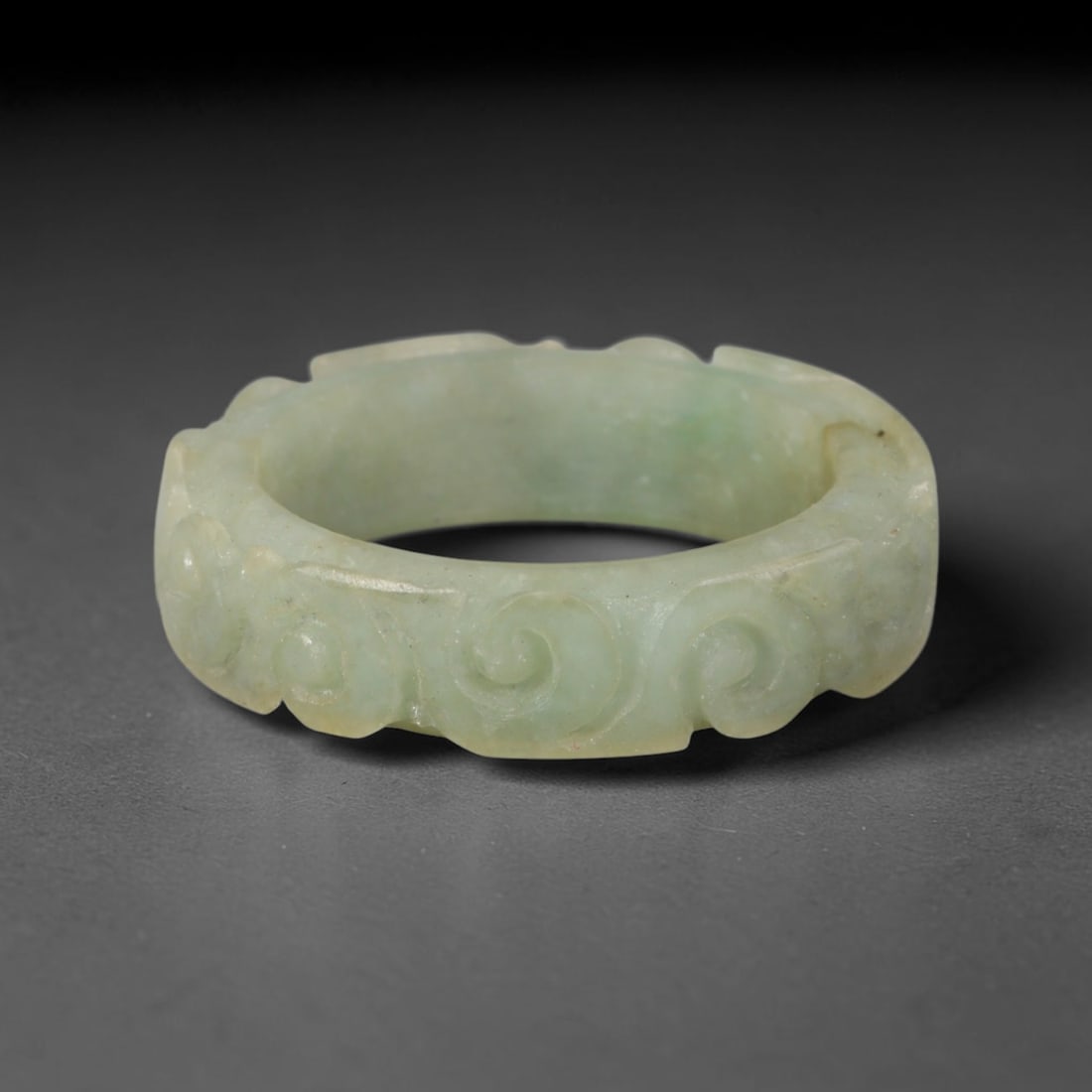 Natural Burmese Type A Jadeite Jade Carving Band Ring Size US 12, 20TB: Carved from untreated natural Burmese Type A jadeite jade, this carved stone band holds a soft polished finish showcasing milky pale base hues interspersed with warm natural brown mineral patina patch