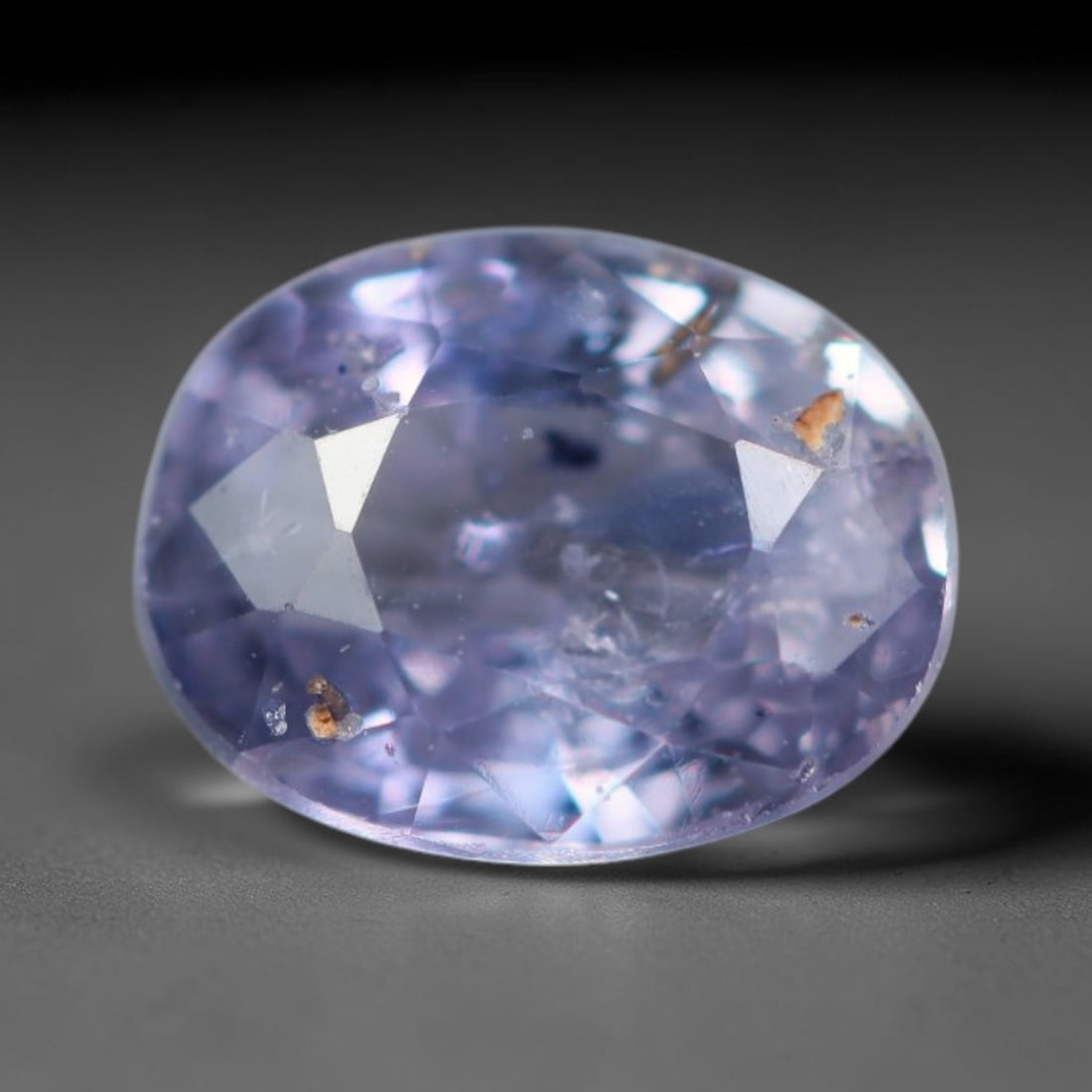 0.60 Carats Natural Muted Lavender Sapphire Loose Faceted Gemstone, 16XM: Natural soft muted lavender corundum sapphire expertly oval faceted loose gemstone, mixed brilliant facets deliver gentle light play and display a translucent pale lilac tone across the crystal body. 