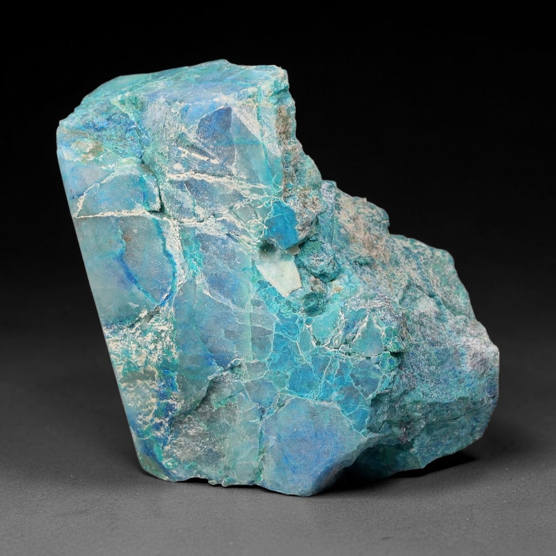168ct Natural Peruvian Chrysocolla Polished Slab Rough, 44WV: This partial-polished chrysocolla slab features blended mineral matrix with smooth refined face and unaltered natural rugged edge across its 42x33x15mm elongated form, translucent mineral layers hold 