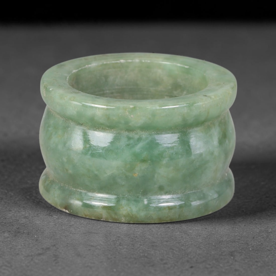 Natural Burmese Type A Jadeite Jade Band Ring Size US 9.50, 4TB: Fashioned from untreated natural Burmese Type A jadeite jade, this solid stone band carries a smooth polished finish showcasing milky pale base tones blended with soft natural green mineral undertones