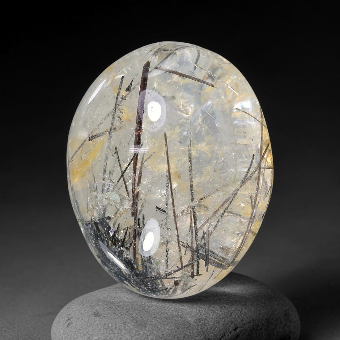 30.71ct Natural Brazilian Black Rutile Quartz Cabochon Loose Gemstone, 16YX: This polished cabochon of natural rutile quartz features countless distinct slender black rutile needle inclusions suspended within the clear quartz host crystal. The smooth domed surface enables full
