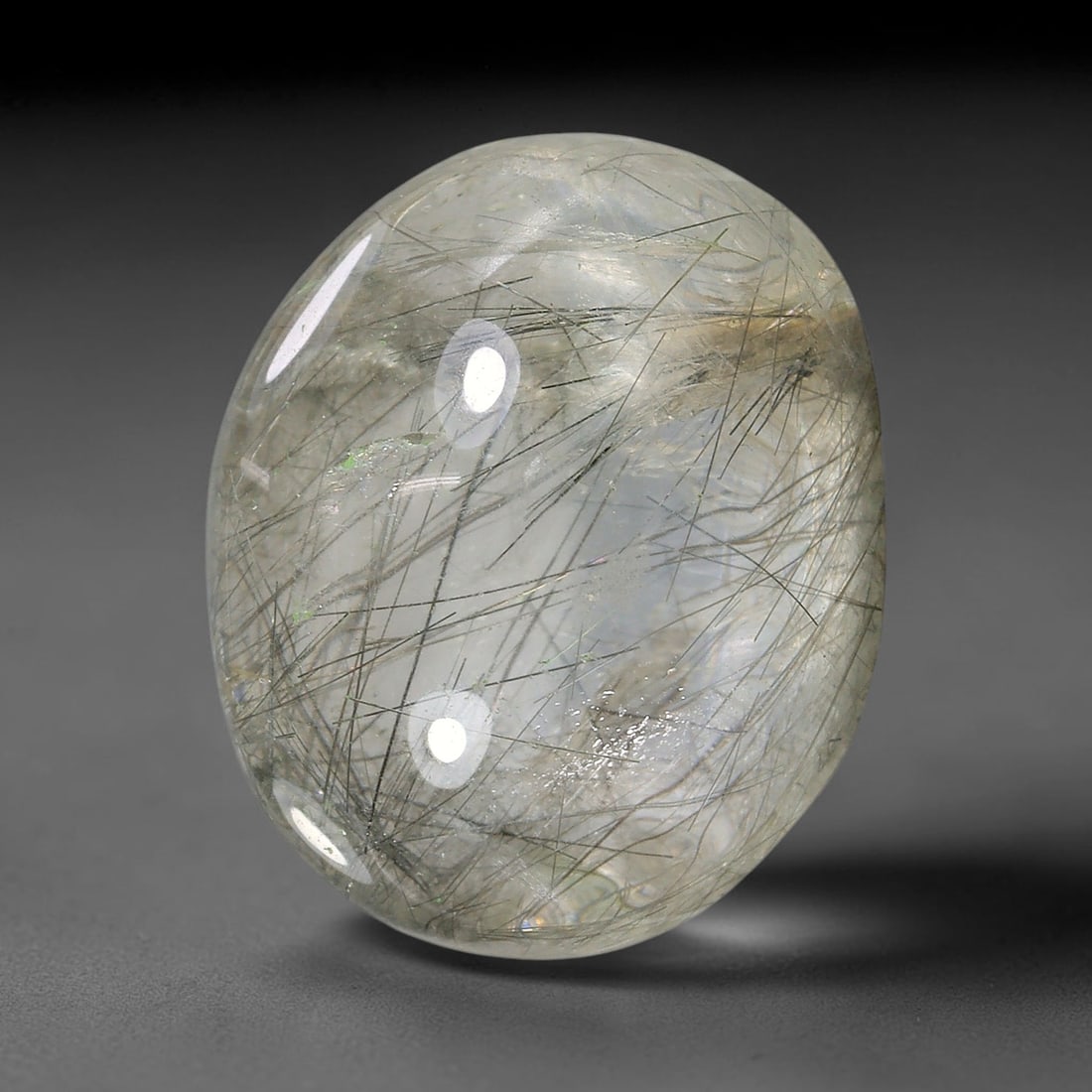 15.68ct Natural Brazilian Black Rutile Quartz Cabochon Loose Gemstone, 2YX: This polished cabochon of natural rutile quartz features countless distinct slender black rutile needle inclusions suspended within the clear quartz host crystal. The smooth domed surface enables full