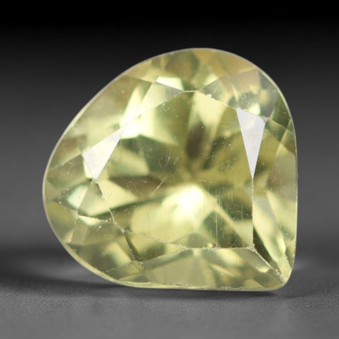 1.93 Carats Natural Pale Yellow Apatite Faceted Loose Gemstone, 48XY: This apatite specimen is sourced from natural geological deposits and shaped with professional faceting and high-gloss polishing work across the outer facet surfaces. Minute internal mineral inclusion