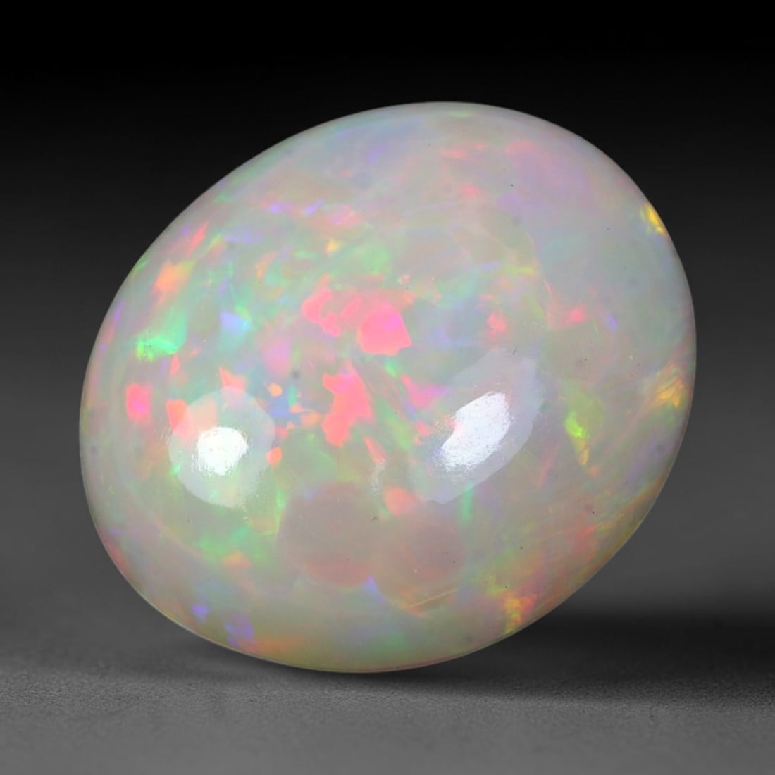 9.63ct Natural Ethiopian Welo Solid Opal Oval Cabochon Loose Gemstone, 17TG: Solid opal cabochon sourced from Ethiopia's Welo opal mining fields, polished into a plump rounded oval dome with mirror-smooth high-gloss finishing. The pale translucent milky base is densely covered