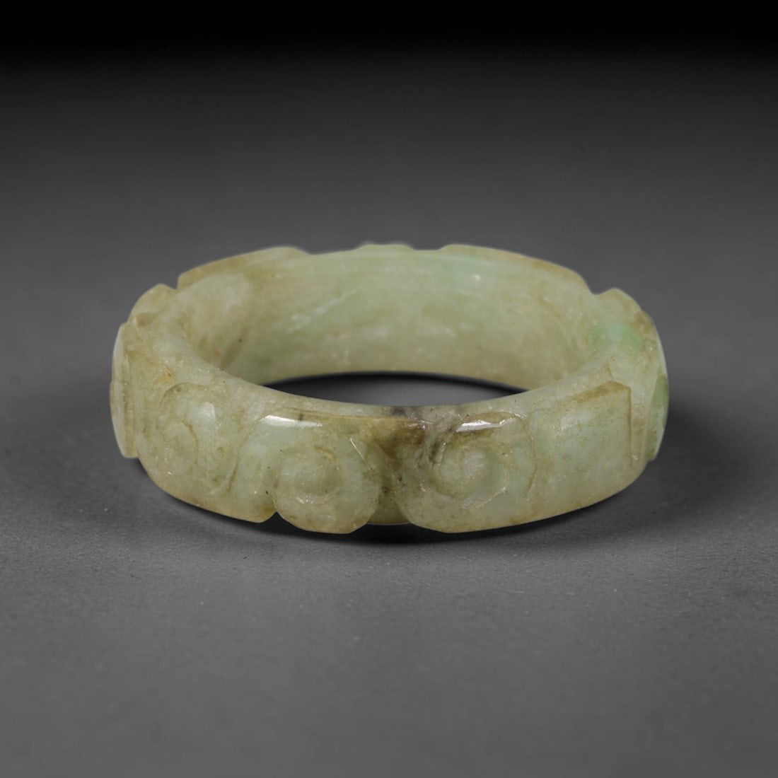 Natural Burmese Type A Jadeite Jade Carving Band Ring Size US 11.5, 14TB: Carved from untreated natural Burmese Type A jadeite jade, this carved stone band holds a soft polished finish showcasing milky pale base hues interspersed with warm natural brown mineral patina patch