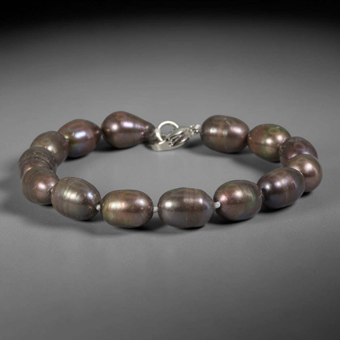 Natural Freshwater Pearl Bracelet - Baroque Peacock Dark Pearl Strand, 89YM: Hand-strung medium baroque natural freshwater pearls featuring deep peacock dark iridescence, with shifting purple, bronze and teal multi-tonal overtones across smooth oval organic bead shapes. No spa