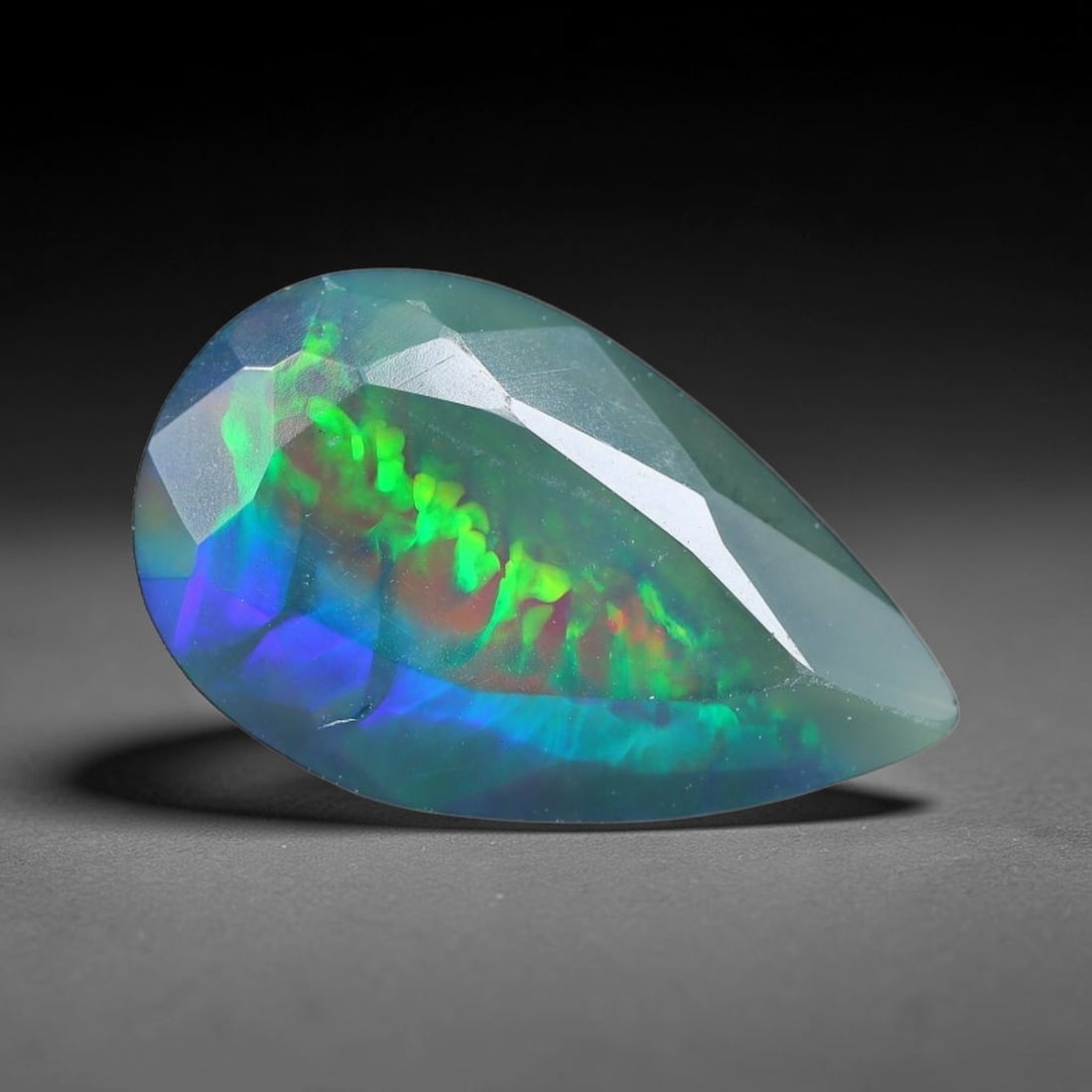 1.88 Carats Natural Ethiopian Welo Black Opal Oval Faceted Loose Gemstone, 87XX: This opal is mined from the Welo region of Ethiopia and expertly faceted and polished into an oval shape by professional lapidary techniques. Natural fine internal particles and faint natural fissures