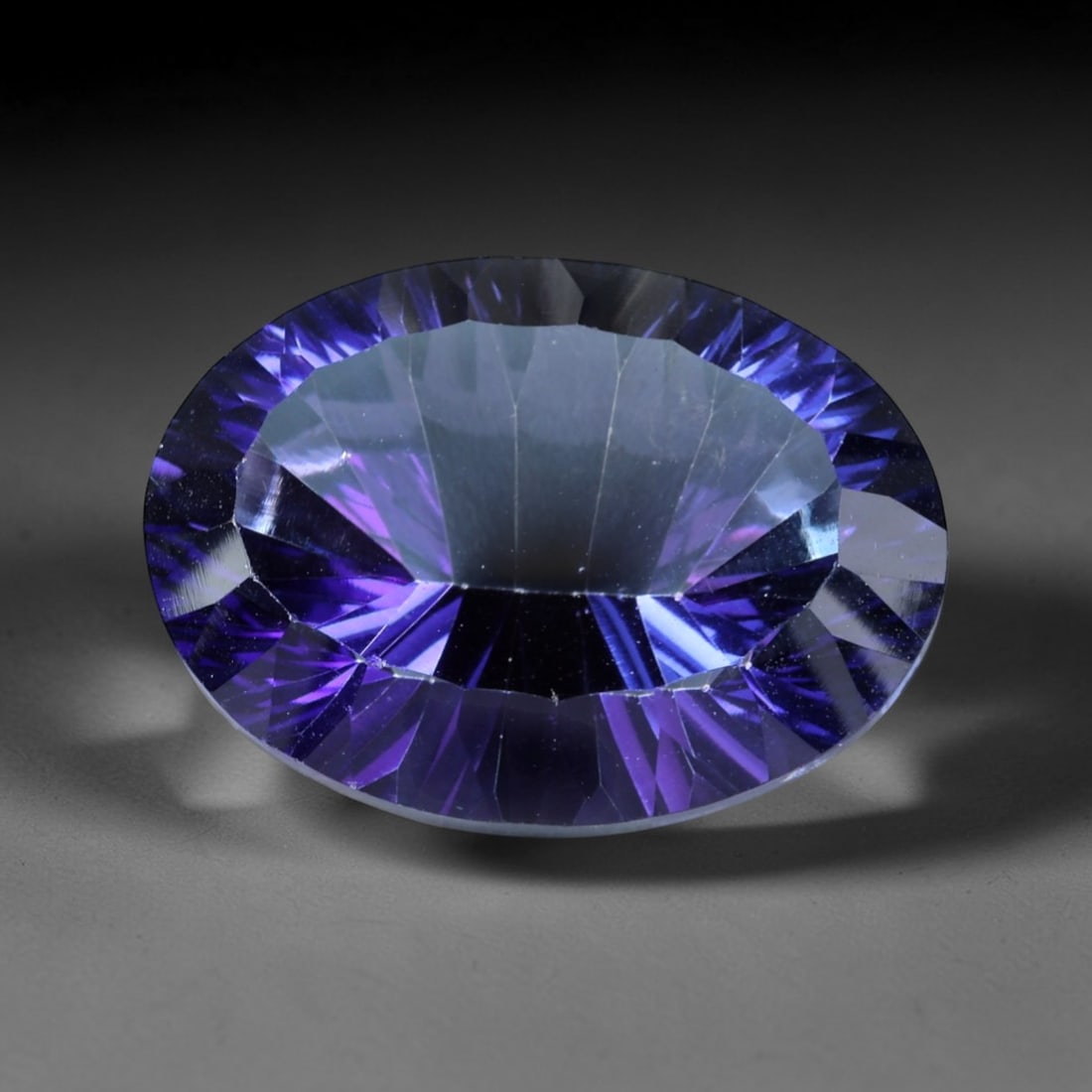 19.37ct Natural Purple Violet Topaz Oval Loose Faceted Gemstone, LZ543: This natural oval faceted topaz weighs 19.37 carats with precise dimensions of 19.4x14.6x9.4mm. It boasts a mesmerizing gradient purple-violet color scheme, featuring deep saturated royal purple along