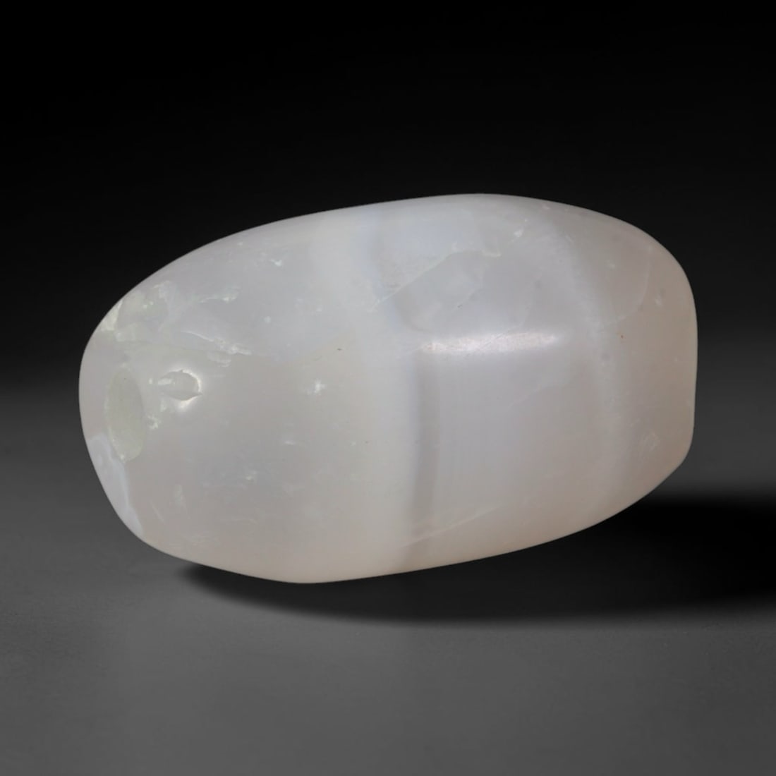 Ancient Han Dynasty Banded Agate Barrel Bead (202 BCE-220 CE), 67XD: This antique pale milky banded agate barrel bead originates from the Han Dynasty, a pivotal East Asian civilization that established large-scale domestic agate carving and circulated chalcedony luxury