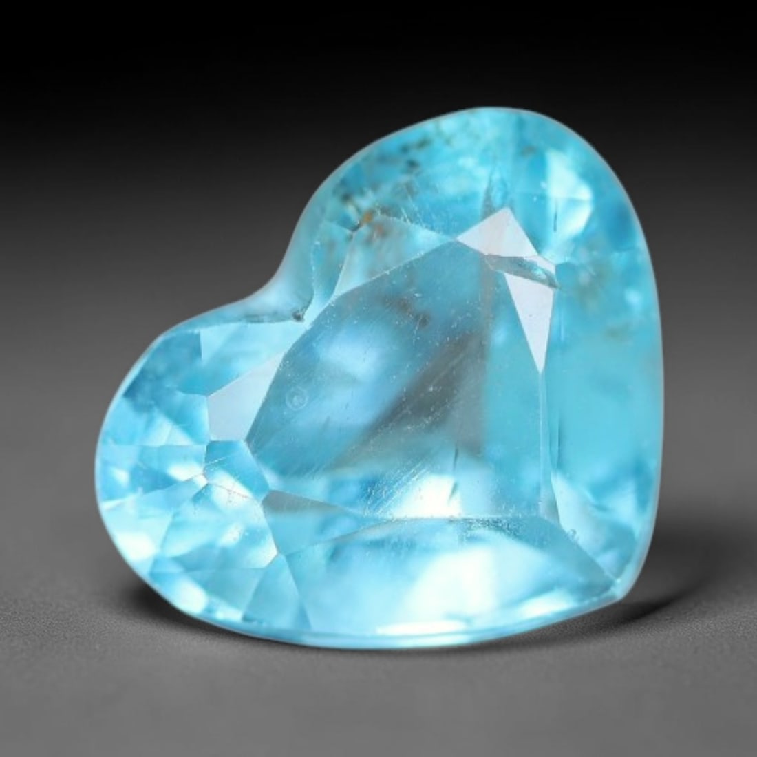 1.05 Carats Natural Bright Cyan Blue Apatite Heart Faceted Loose Gemstone, 18WW: This apatite is sourced from natural mineral deposits and processed with precise faceting and uniform high-gloss polishing by professional lapidary craftsmanship. Natural fibrous textures and tiny sca