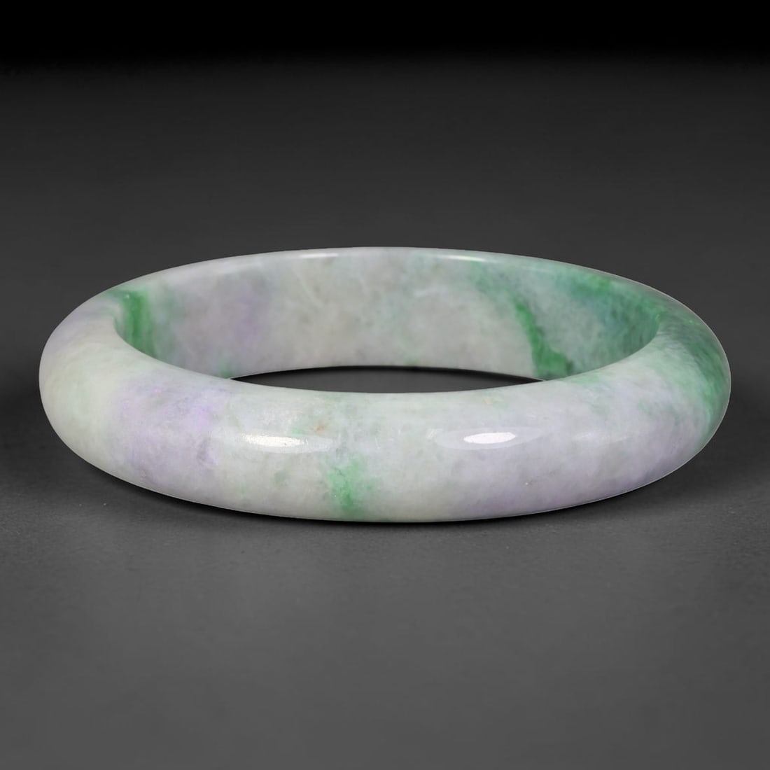 Natural Burmese Type A Jadeite Jade Bangle Bracelet, 8TD: Crafted from natural Burmese type-A jadeite, this wide substantial bangle displays soft lavender-lilac base tone accented by vibrant streaks of fresh emerald-green flowing across the band. The bangle 