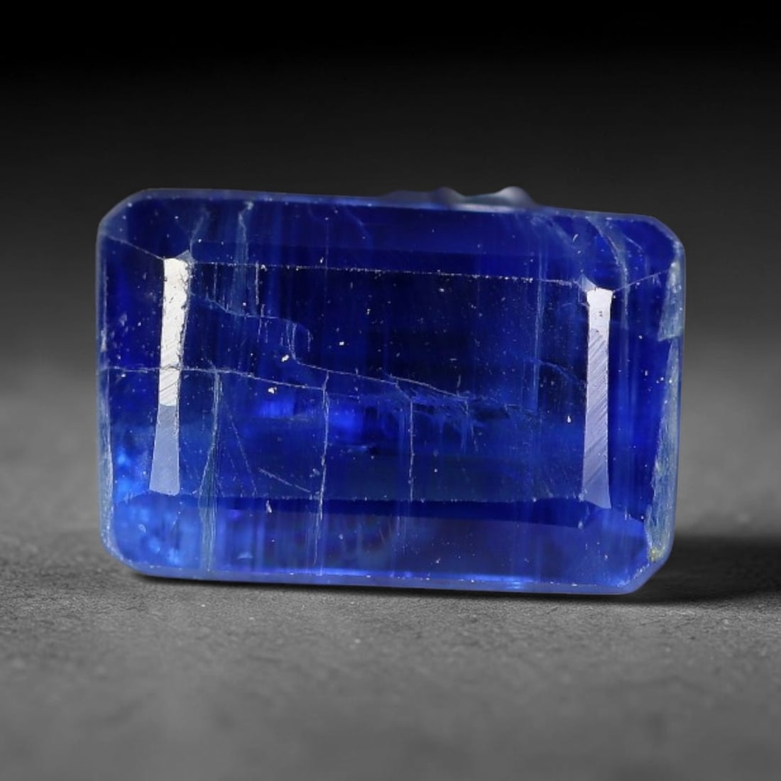 1.68 Carats Natural Vivid Royal Blue Rectangular Kyanite Step Cut Loose Gemstone, 30XV: Natural intense saturated royal blue kyanite expertly rectangular emerald step cut loose gemstone, linear parallel facets amplify deep rich blue saturation, showcasing striking vertical silvery fibrou