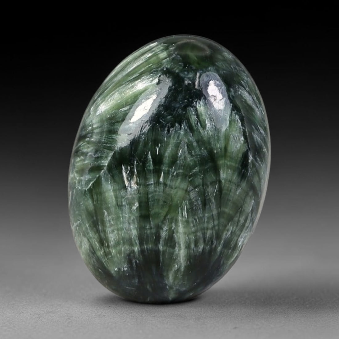 9.21 Carats Natural Deep Green Siberian Seraphinite Polished Cabochon, 99WW: This is a fully natural polished seraphinite specimen sourced from Siberian deposits, displaying distinct feathery fibrous inclusions that create beautiful flowing chatoyant patterns across its smooth