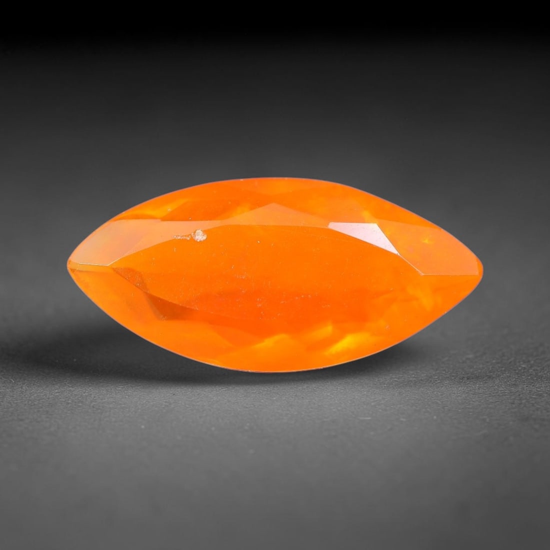 1.61 Carats Natural Ethiopian Welo Orange Fire Opal Marquise Faceted Loose Gemstone, 84XX: This opal material is mined from the Welo deposits of Ethiopia and processed with professional faceted lapidary work with uniform polished facets across the gem surface. Natural subtle internal textur