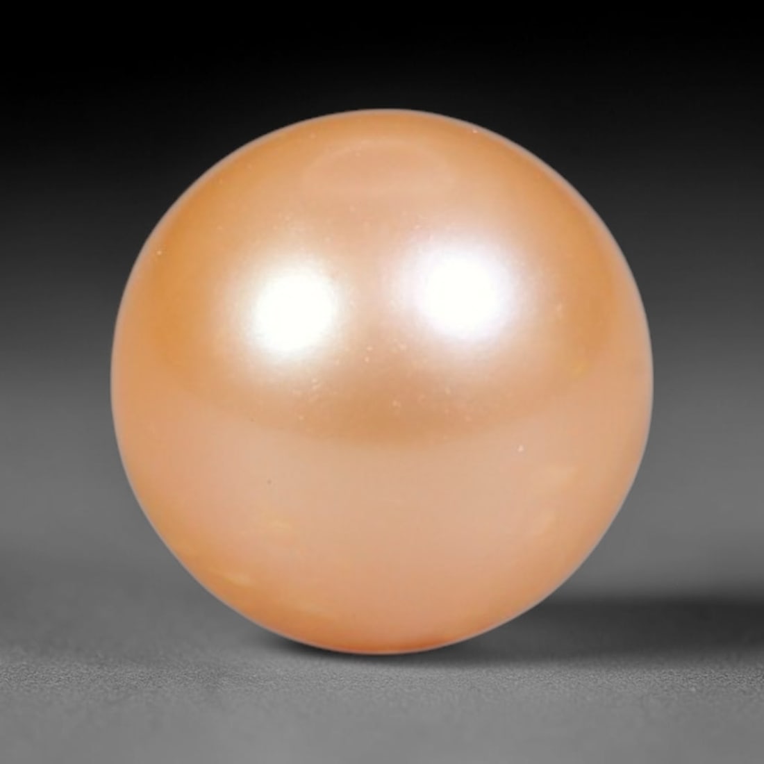 2.50ct Natural Round Freshwater Peach Pink Pearl Loose Gemstone 7.2mm, 47XZ: Flawless natural undrilled round freshwater pearl, showcasing a smooth symmetrical spherical form with soft gradient peach blush nacre transitioning from warm apricot crown to pale pink base. The pear