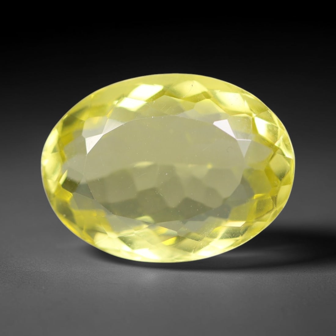 11.65 Carats Natural Brazilian Lemon Quartz Oval Faceted Loose Gemstone, 9XX: This lemon quartz is sourced from natural mineral deposits within Brazil and refined through standard professional faceted lapidary procedures, accompanied by uniform glossy polishing across the full 