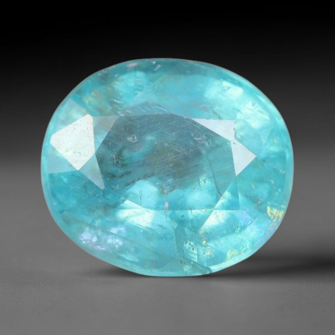 1.89 Carats Natural Bright Cyan Blue Apatite Oval Faceted Loose Gemstone, 12WW: This apatite is sourced from natural mineral deposits and processed with precise faceting and uniform high-gloss polishing by professional lapidary craftsmanship. Natural fibrous textures and tiny sca