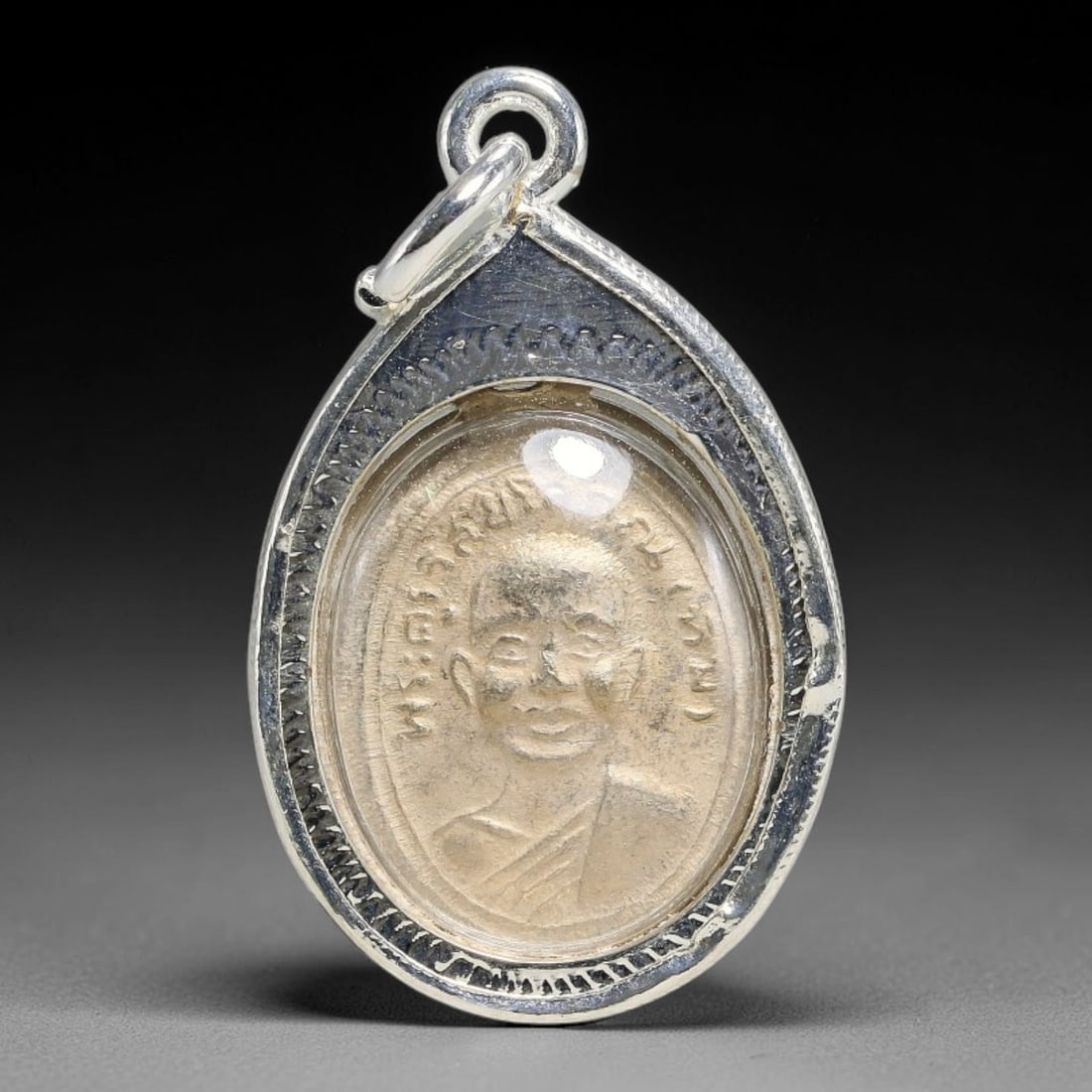 Thai Teardrop Monk Portrait Amulet with Engraved Silver Metal Casing, 53YY: Classic teardrop shaped Thai monk talisman encased in polished silver frame with detailed hand-carved leaf border patterns and transparent protective cover. Dual-sided design features distinct revered