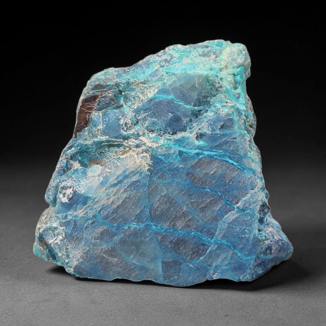 59ct Natural Peruvian Chrysocolla Polished Slab Rough, 48WV: This partial-polished chrysocolla slab features blended mineral matrix with smooth refined face and unaltered natural rugged edge across its 27x26x11mm elongated form, translucent mineral layers hold 