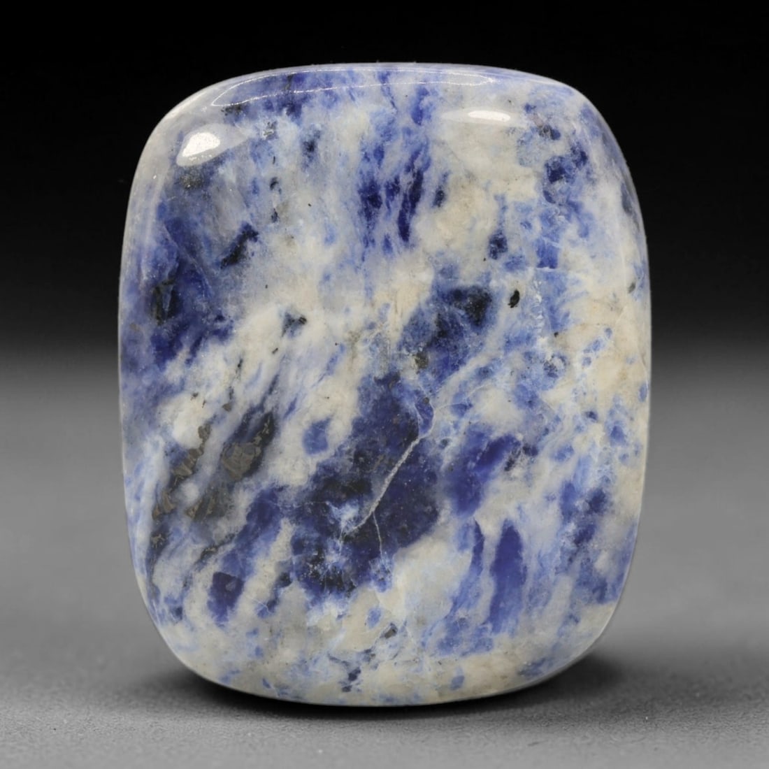 72.30 Carats Denim Blue Sodalite Cushion Cabochon - Natural Brazilian Stone, 98XB: This substantial 72.30 carat sodalite cabochon, measuring 36.2 x 30.2 x 6.8 mm, presents a striking, painterly display of denim blue, crisp white, and subtle black veining. Polished into a soft cushio