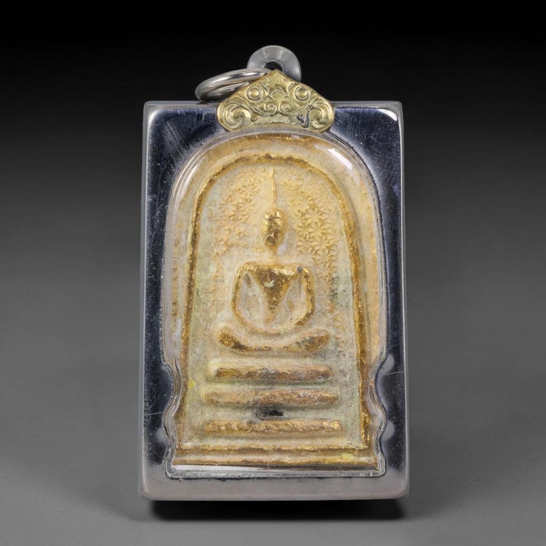 Thai Gilded Clay Metal Amulet Buddhist Votive Pendant, 45ZB: Crafted from fired clay with layered gilded surface finishes, the piece uses traditional molded production techniques common to Southeast Asian devotional craftwork. Its rectangular silhouette follows