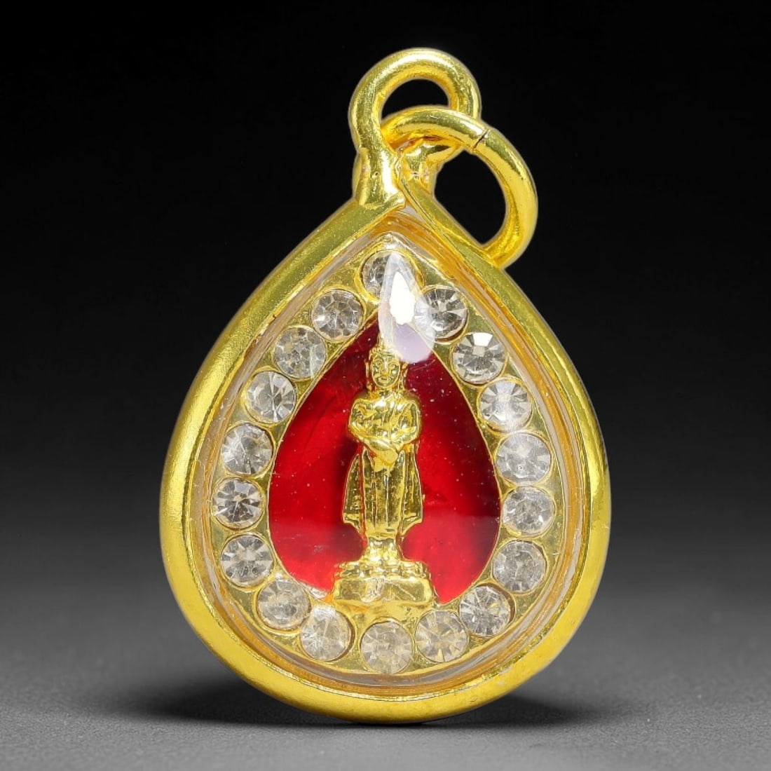 Thai Standing Buddha Dual-Sided Gold Plated Rhinestone Casing Amulet, 77YY: Mini teardrop-shaped Thai standing Buddha amulet with gold metal core sealed under transparent cover, set inside sparkling rhinestone border gold-plated metal casing with matching gold loop. Size: 2.5