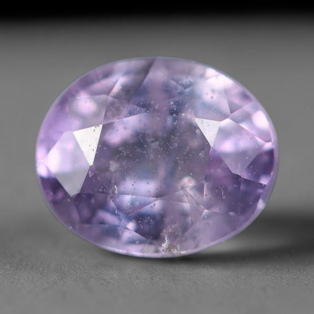 0.77 Carats Natural Lavender Purple Sapphire Oval Faceted Loose Gemstone, 68XV: Natural soft lavender purple corundum sapphire expertly cut into an oval faceted loose gemstone, fitted with mixed brilliant facets to enhance gentle purple hue and light sparkle. The crystal carries 