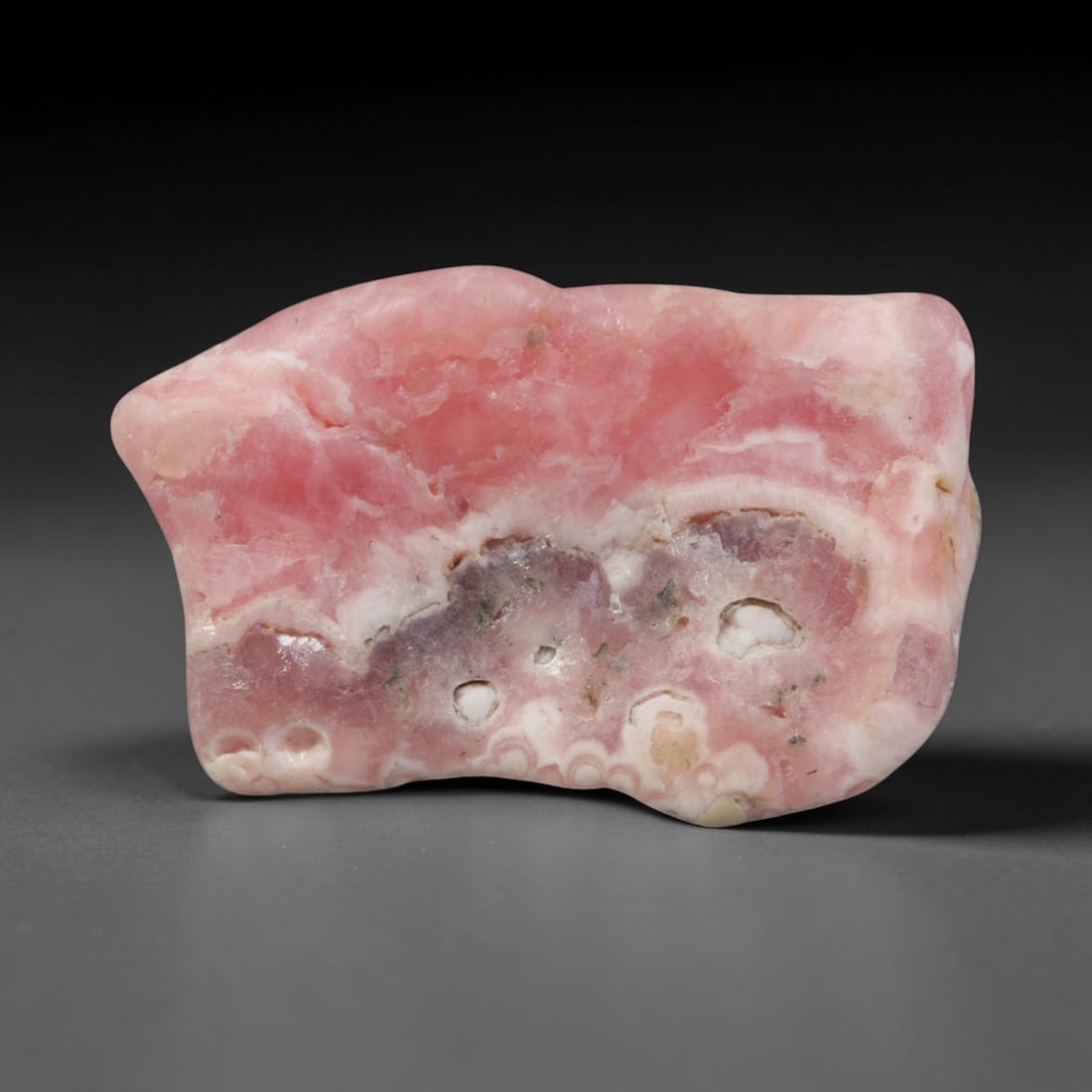 59ct Natural Argentine Rhodochrosite Tumbled Banded Rough Specimen, 99YQ: This smooth rounded rough specimen is natural banded rhodochrosite sourced from Argentina's Capillitas mining district, displaying characteristic layered concentric banding of soft blush pink, creamy 