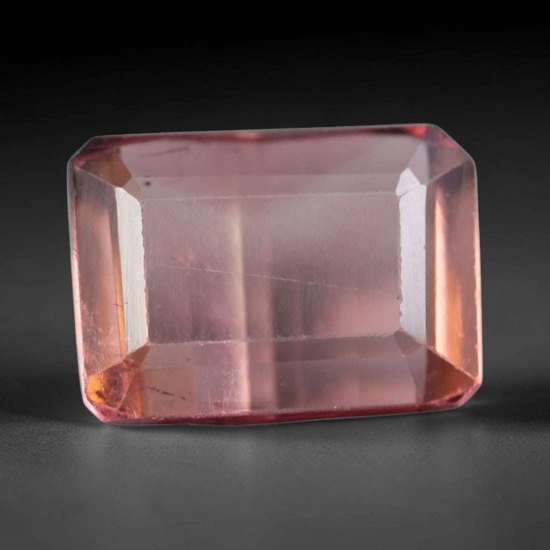 2.31 Carats Natural Peach Pink Tourmaline Emerald Faceted Loose Gemstone, 55WS: This sleek emerald faceted tourmaline displays soft peach pink color glowing through smooth polished step facets, with faint thin natural internal fine lines and tiny mineral specks visible within the