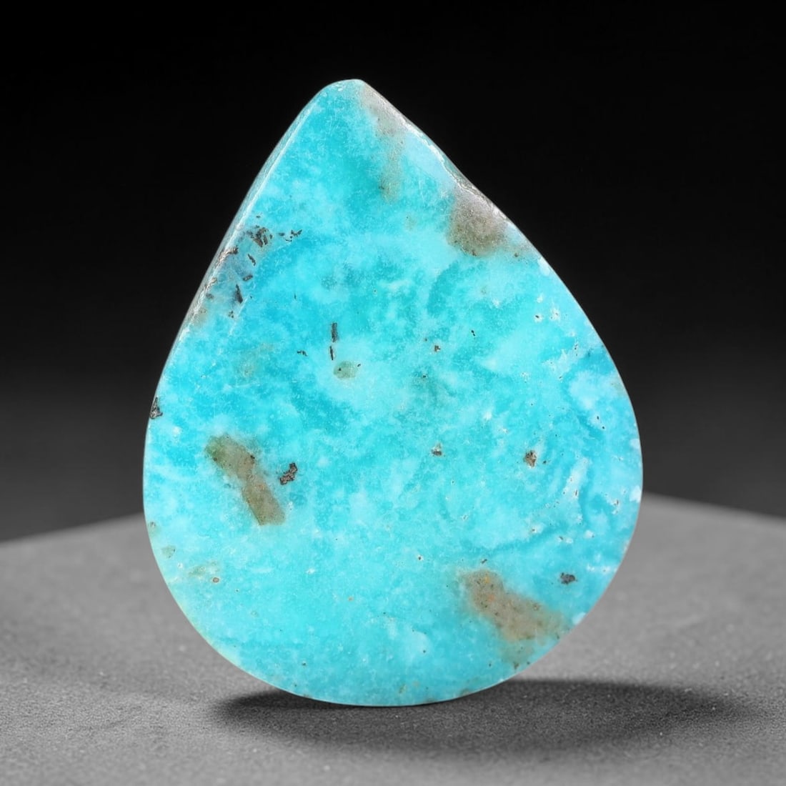 13.93ct Natural Turquoise Pear Cabochon Loose Gemstone, 88WW: Hand polished natural turquoise cabochon featuring attractive sky-blue base colour naturally scattered with earthy mineral matrix specks and subtle native inclusions across the smooth surface. The sto