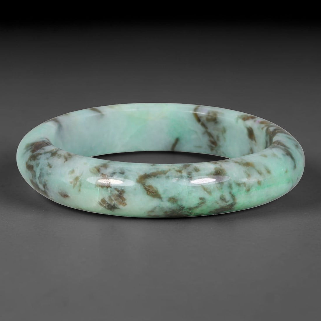 Natural Burmese Type A Jadeite Jade Bangle Bracelet, 3TD: Crafted from natural Burmese type-A jadeite, this substantial wide bangle features a bright mint-green base heavily interwoven with rugged brownish-black dendritic mineral inclusions spanning the full