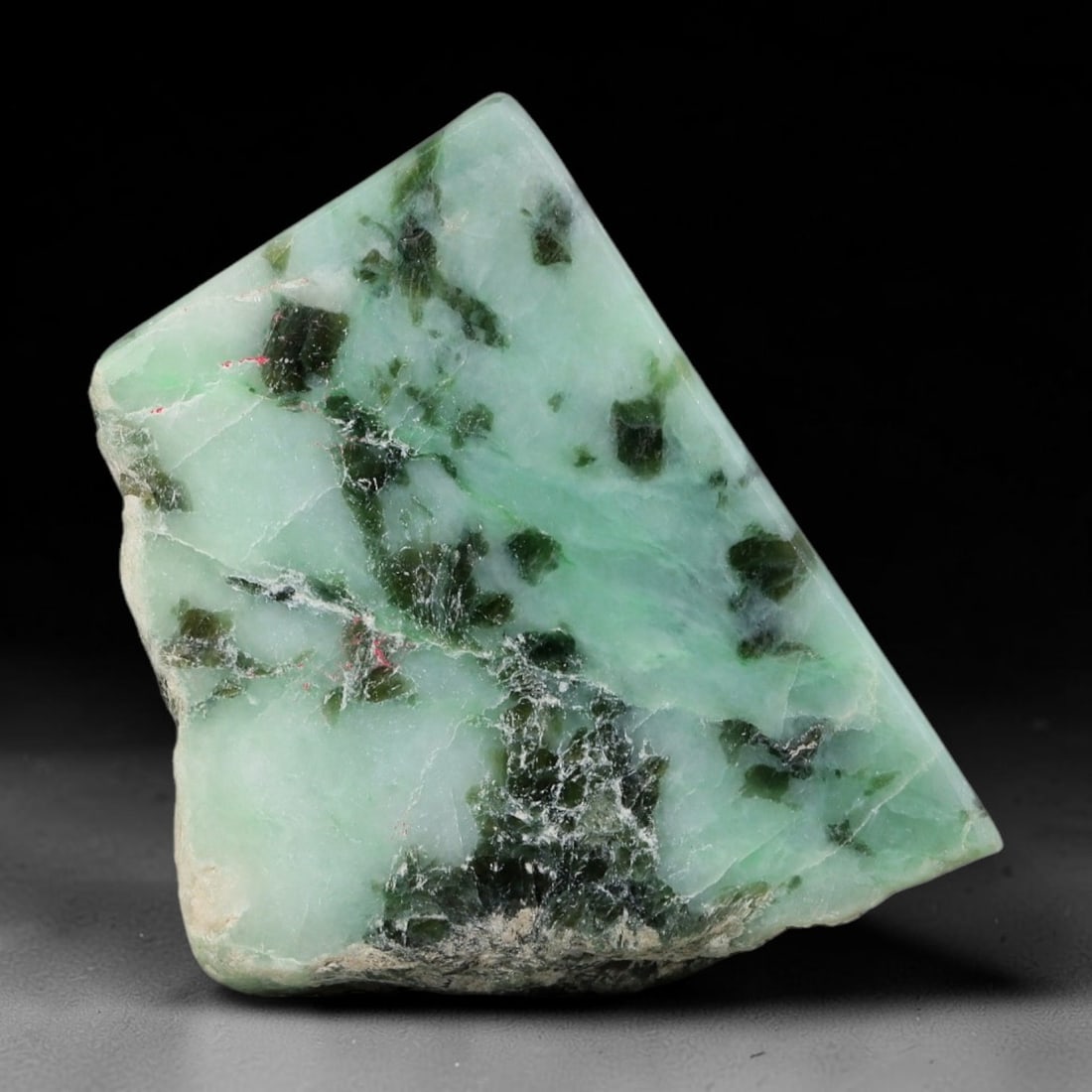 175ct Natural Type A Burmese Jadeite Jade Sliced Rough, 49YR: This specimen is a sliced rough block of natural Type A Burmese jadeite jade. The interior displays natural colour zoning with visible mineral veining and crystalline patterns typical of unprocessed j