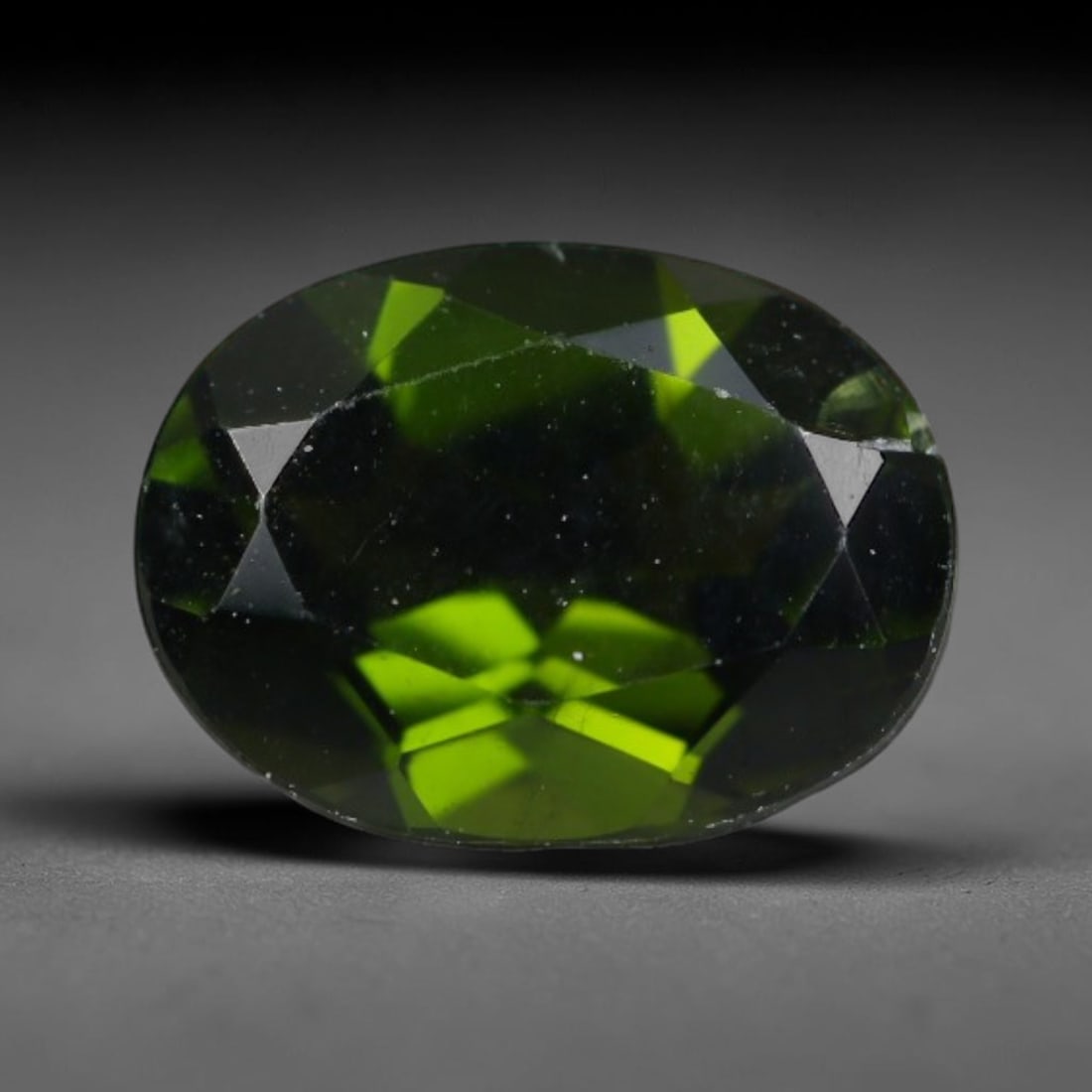1.41 Carats Natural Vivid Chrome Green Chrome Diopside Oval Faceted Loose Gemstone, 48WS: This striking chrome diopside faceted oval stone showcases vivid intense chrome green color illuminated through crisp polished step facets, with fine tiny natural mineral speckles visible within the t