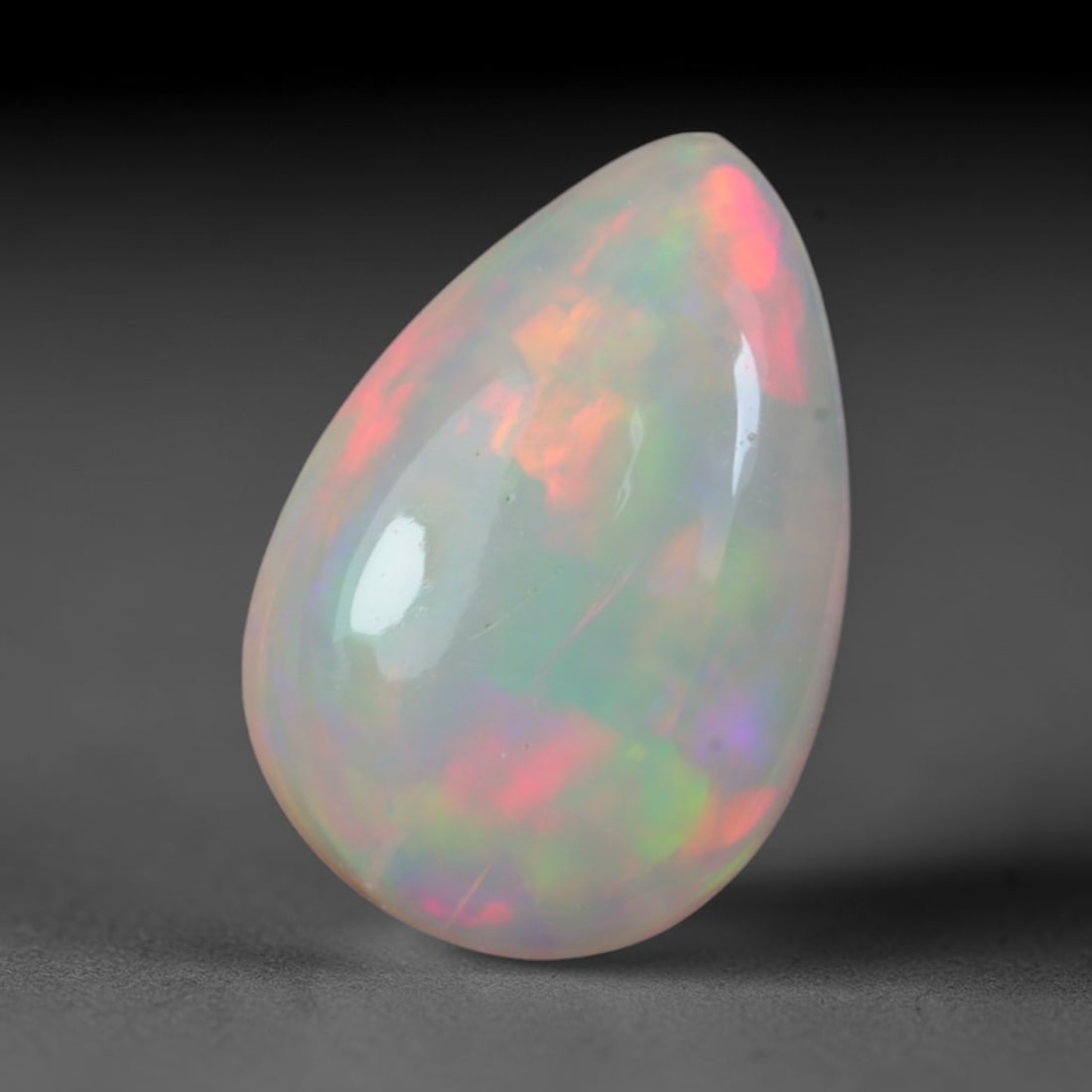 2.15 Carats Natural Ethiopian Welo Opal Oval Cabochon Loose Gemstone, 54XV: Natural Ethiopian Welo opal polished oval cabochon loose gemstone, luminous translucent milky white base stone with vivid multi-hued play-of-color featuring bright emerald green, lime yellow, soft blu