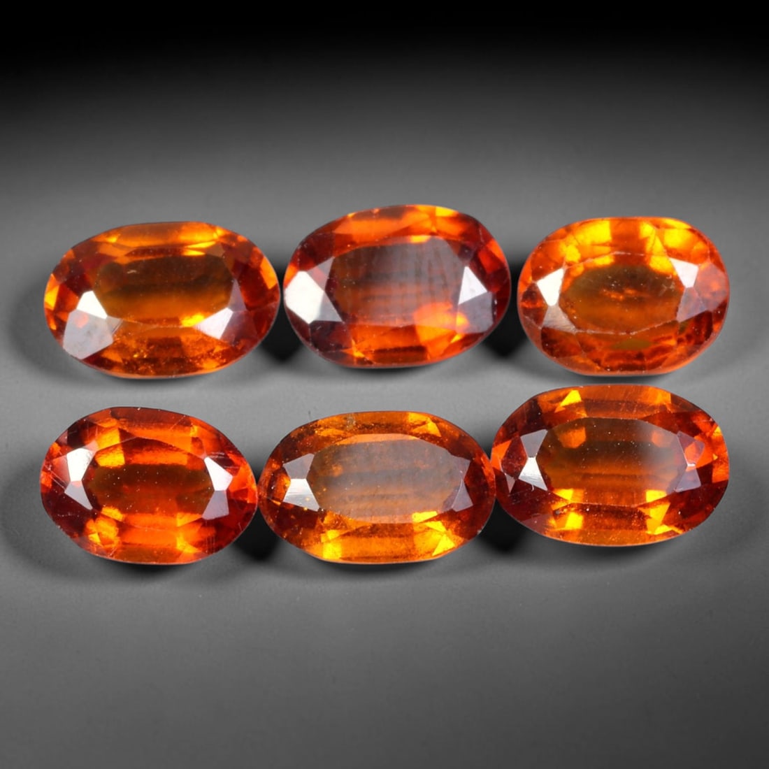 7.62ct Natural Hessonite Garnet Oval Faceted Parcel Loose Gemstone, 97XX: Matching parcel of hand faceted natural hessonite garnet gemstones featuring rich warm orange-brown hue with subtle inherent mineral characteristics within each stone. Precision faceting and glossy hi