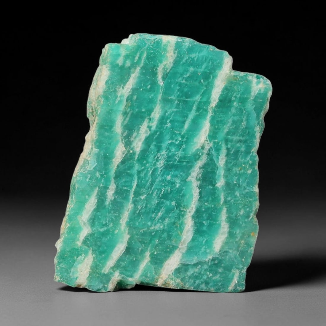 38ct Natural Russian Ural Amazonite Slab Rough, 50WV: This intact amazonite slab features distinct parallel mineral banding running uniformly across its naturally split flat surface within 29x21x5mm slab dimensions, retaining unmodified natural geologica