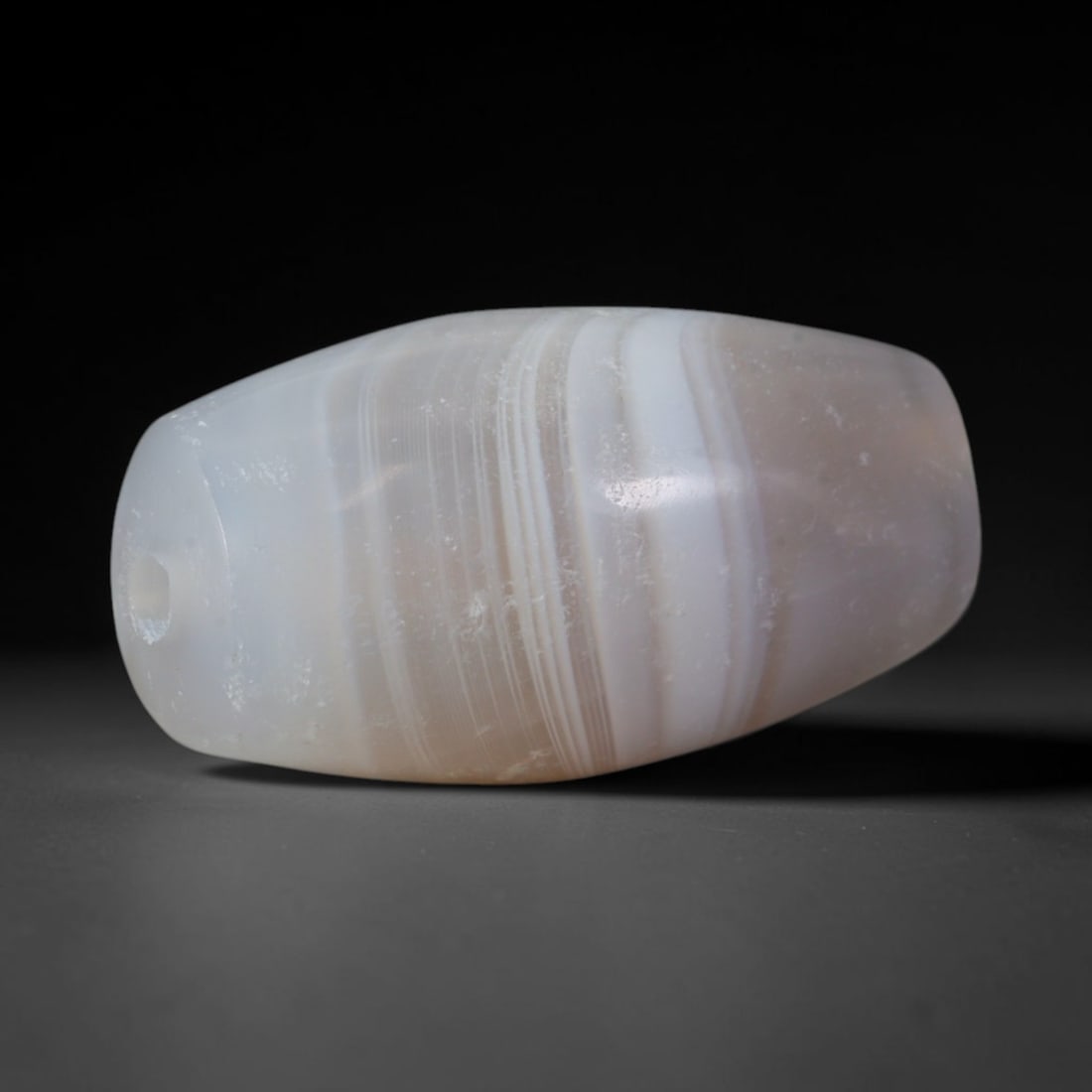 Ancient Medieval Umayyad & Abbasid Cultures Banded Agate Barrel Bead (661-1258 CE), 63XD: This antique banded agate barrel bead originates from Umayyad & Abbasid Islamic Mesopotamian Cultures, medieval West Asian artisans specializing in chalcedony talisman and prayer beads traded widely a