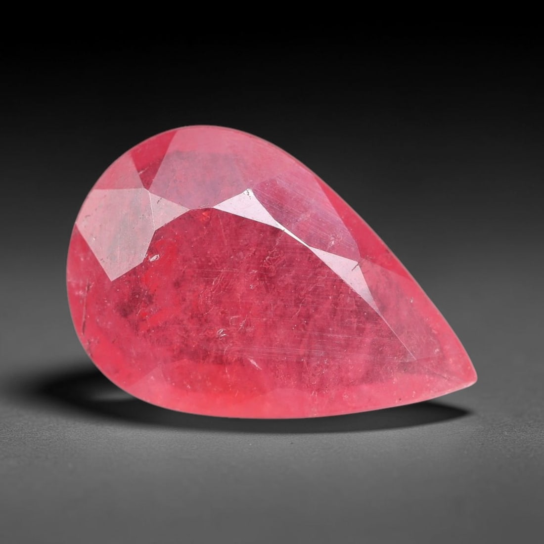 1.64 Carats Natural Orange Sapphire Pear Faceted Loose Gemstone, 96XM: This natural orange sapphire is fashioned in a classic pear brilliant faceted cut, presenting soft warm orange hues consistent with natural corundum specimens. Fine scattered mineral specks and faint 