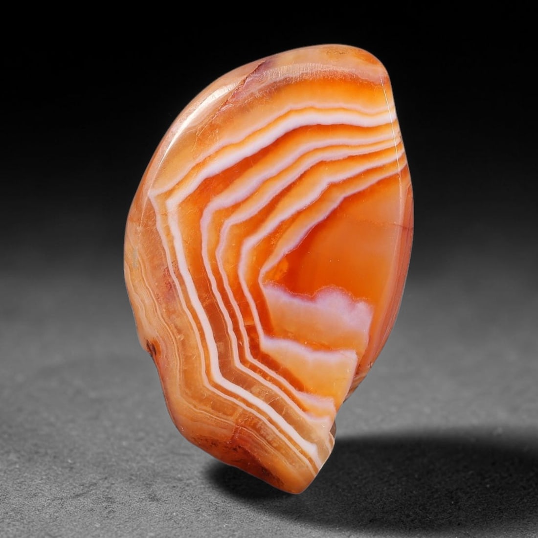 39ct Natural Brazilian Carnelian Banded Agate Sliced Rough Slab, 87YK: This polished slice specimen is natural carnelian banded agate sourced from Brazilian deposits, featuring concentric layered banding of rich orange, peach, and deep crimson-red chalcedony. One flat fa