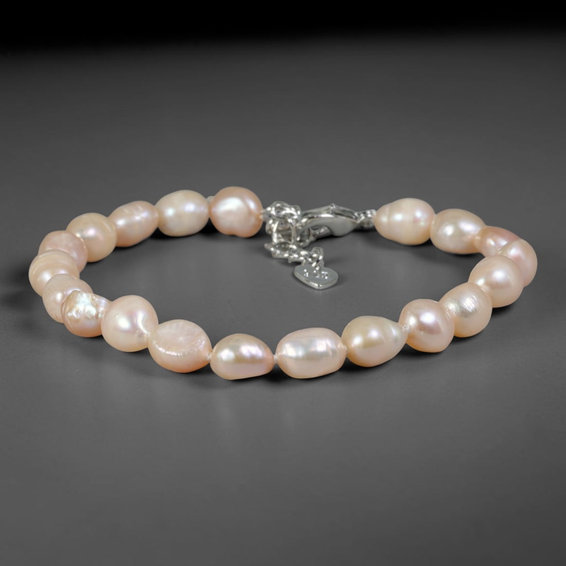 Natural Freshwater Pearl Bracelet - Baroque Pale Peach Pearl Strand, 66YM: Constructed from medium-small organic baroque natural freshwater pearls with soft pale peach pearlescent sheen, each bead bearing unique asymmetrical rounded and oval contours developed through natura