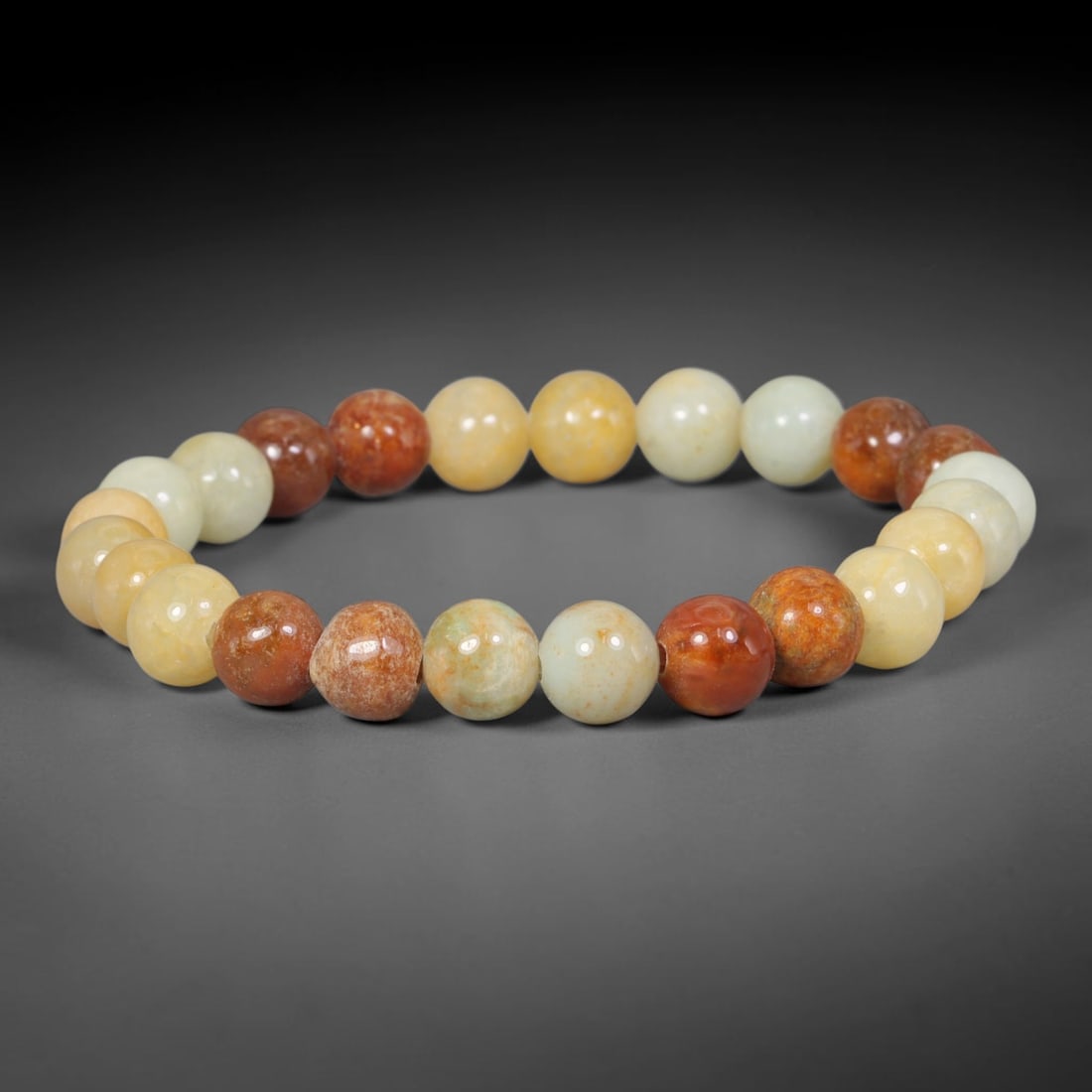 Natural Burmese Type A Multi-Tone Russet Red Golden Cream Jadeite Bracelet, 79TA: Made of entirely untreated genuine Burmese Type A jadeite, this bracelet consists of smooth small round beads showcasing a natural blend of warm russet red, pale golden yellow and soft milky cream ton