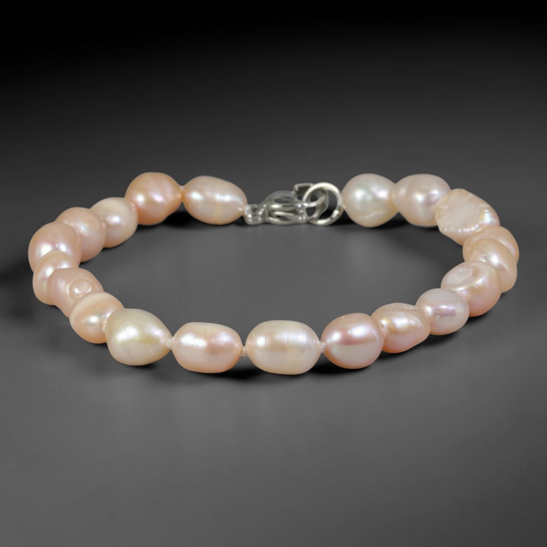 Natural Freshwater Pearl Bracelet - Baroque Soft Peach Pearl Strand, 70YM: Strung from medium organic baroque natural freshwater pearls with uniform soft peach pearlescent luster, each bead holding varied asymmetrical oval and barrel contours formed through natural freshwate