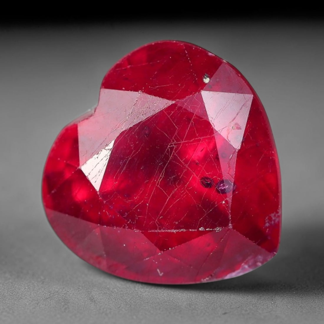 5.61 Carats Natural Madagascar Ruby Heart Faceted Loose Gemstone, 32XM: This natural Madagascar ruby is precision cut into a romantic heart brilliant faceted shape, bearing rich saturated crimson red tone typical of Malagasy corundum deposits. Extensive natural internal s