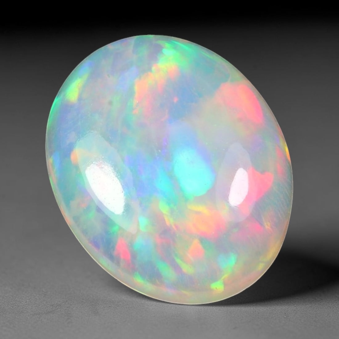 2.19ct Natural Multicolor Fire Ethiopian Welo Solid Opal Cabochon Loose Gemstone, 23TG: Formed from natural silica deposits within Ethiopian mineral veins, this solid opal cabochon is polished to a smooth domed surface that displays inherent light refraction traits. The stone carries wid